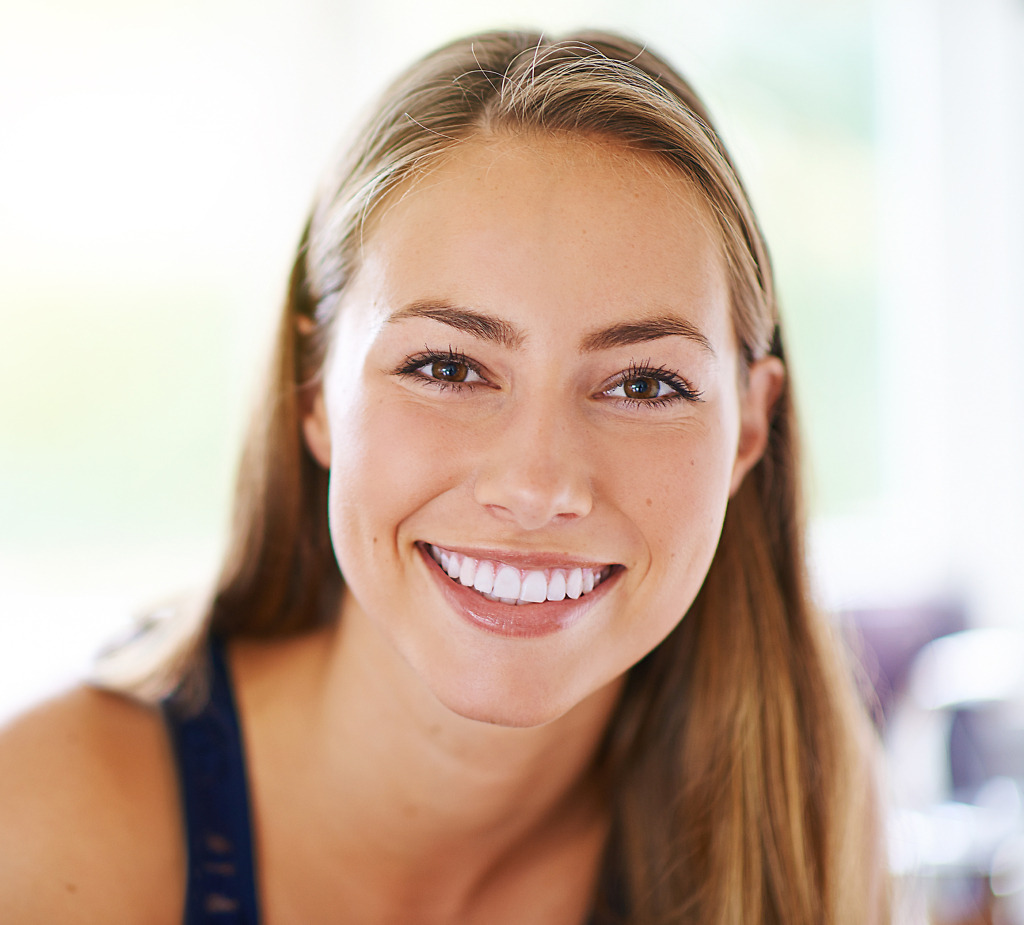 Smiling woman demonstrating Lumineers at Natural Clinic in Turkey