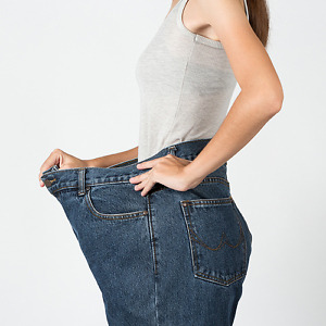 Person wearing oversized jeans, representing significant weight loss results