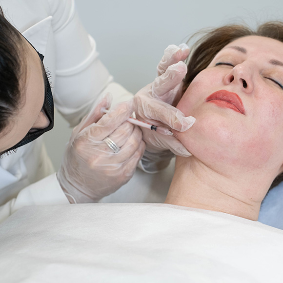 Doctor consulting a patient before chin liposuction procedure